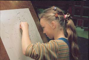 ‘Under the guidance of remedial teacher Corrie Schouten a girl is drawing the exercise ‘The Script’. She is drawing with her non-dominant hand and with her eyes open’.